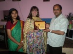 receiving a  plaque of thanks for the days of teaching